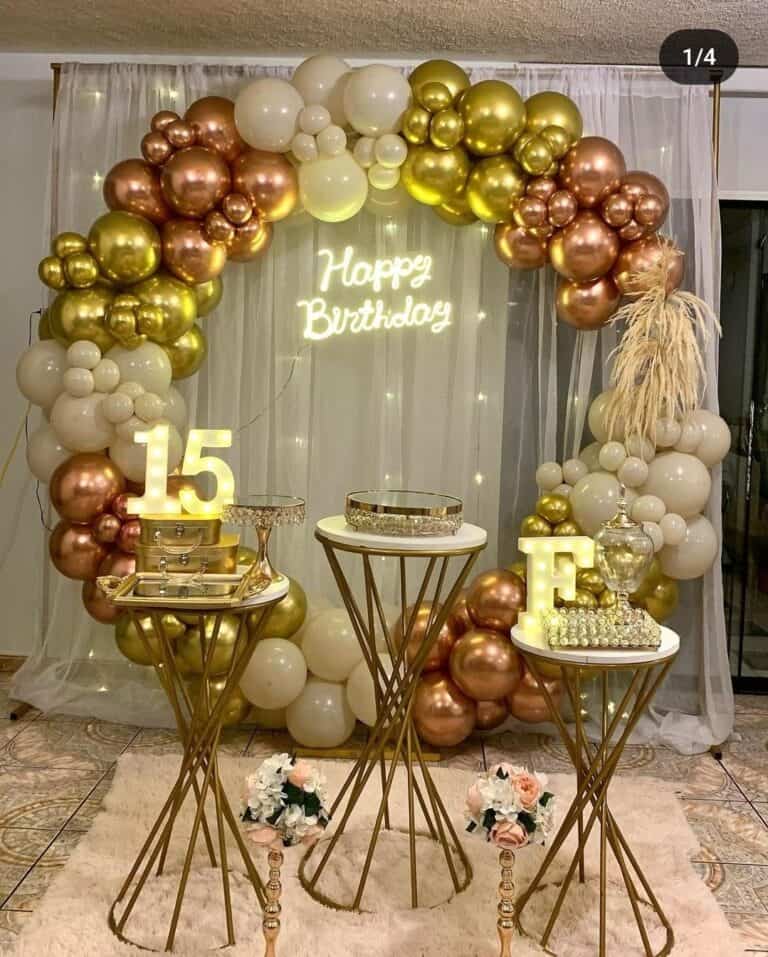 Elegant balloon arch with chrome and matte balloons for a birthday celebration.