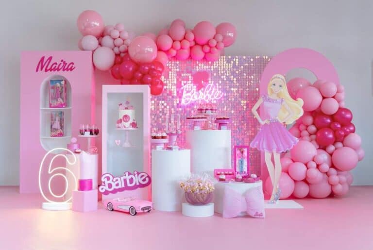 A vibrant pink Barbie Dreamland themed birthday party setup with balloon arches, a shimmering sequin backdrop, a large Barbie cutout, custom pedestals with desserts, a personalized display with "Maira" and "6," and a neon "Barbie" sign, suitable for Kids Birthday Decoration Services.